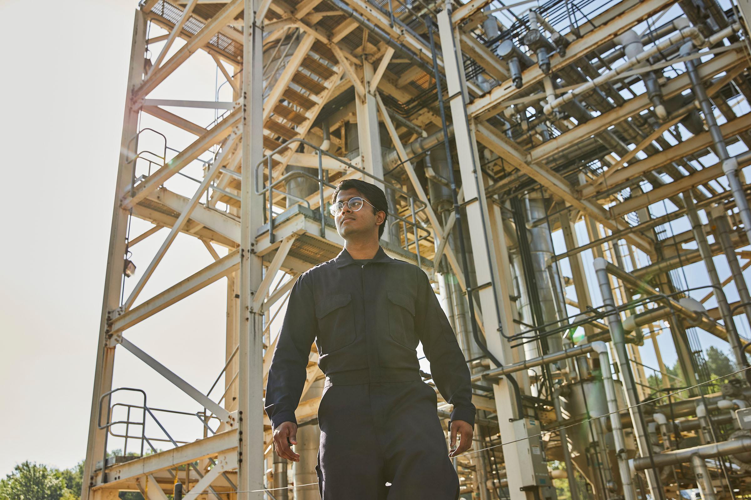 Oil and gas worker preparing for work in navy DH coveralls.