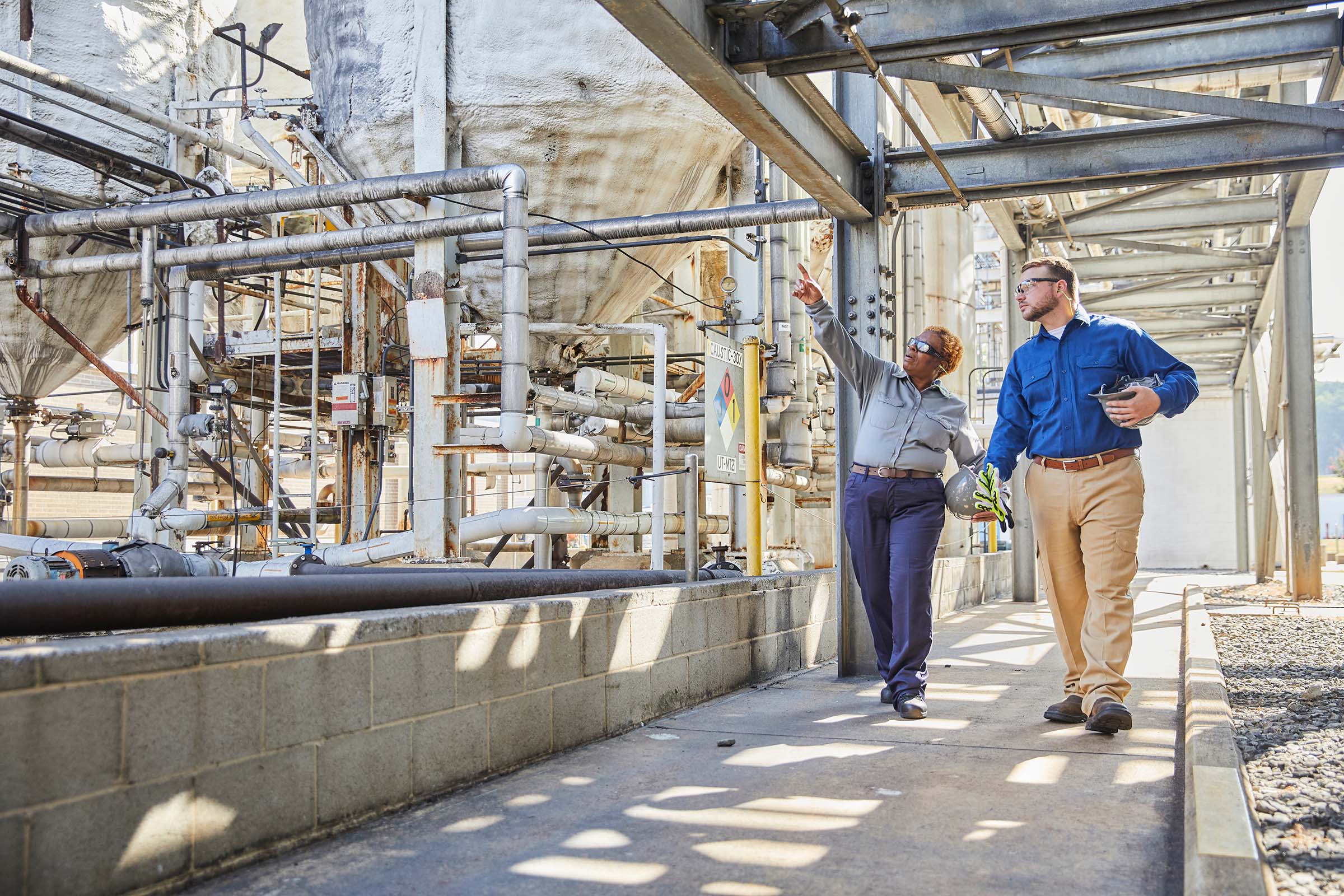 Two manufacturing workers evaluating site in DH and UltraSoft.