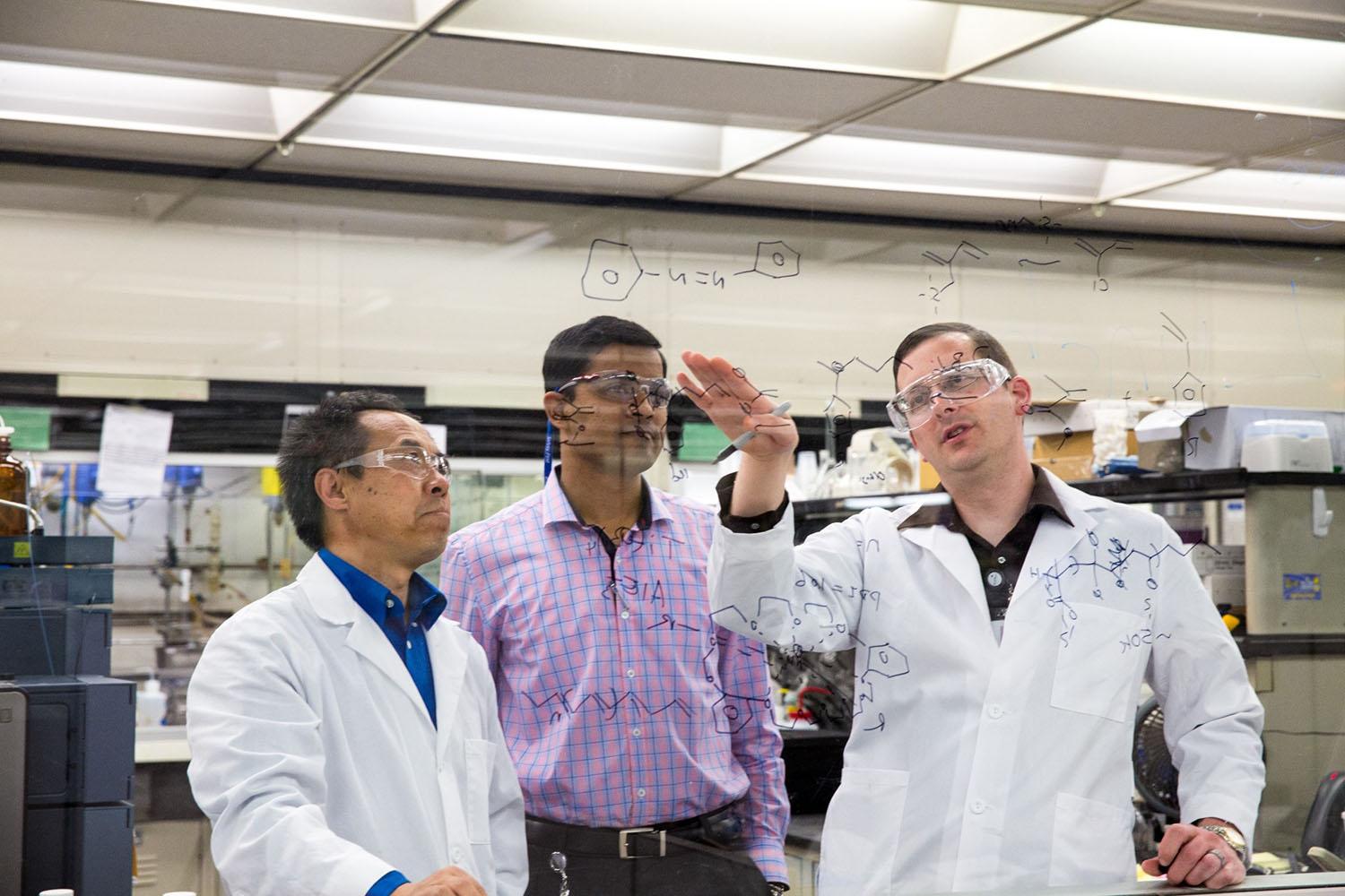 Three scientists collaborating in the lab.